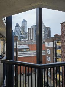 a view of the city from a balcony at Central Luxe Stay - 4 mins to Aldgate East Station in London