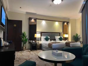 a hotel room with a bed and a couch at Sky View Hotel, Madinah in Medina