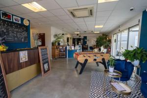a store with a table in the middle of a room at Hotel Caiman in Pierrelatte