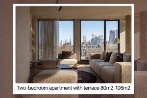 a living room with a couch and a large window at 348 Suites Short Stay in The Hague