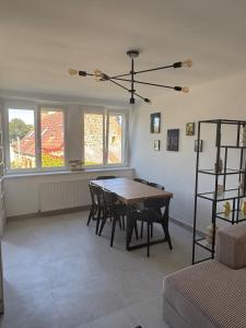 a dining room with a table and chairs at Maison refaite à neuf avec jacuzzi - LE HOMARD 13 in Perros-Guirec