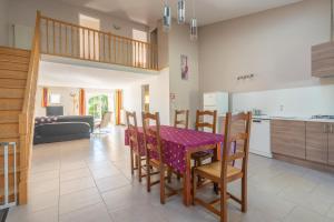 a kitchen and dining room with a table and chairs at Gite à la Campagne in Allas-Bocage