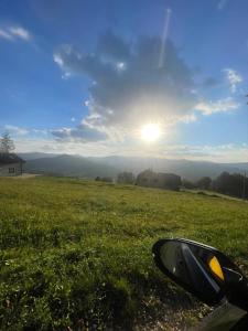 a view from a car window of a field with the sun at Dom nad Wisłą - pobyty rodzinne, grupowe, terapie in Wisła