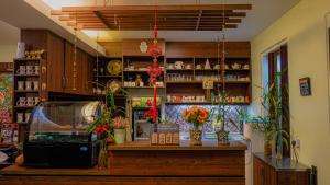 a room with a store with flowers and vases at Highlanders Garden Guesthouse at Arundina Cameron Highlands in Cameron Highlands