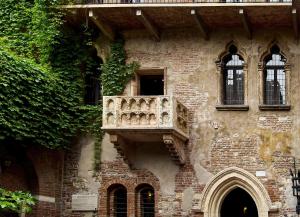 a building with a balcony on the side of it at Love Suite Verona in Verona
