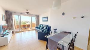a living room with a blue couch and a table at Ginkgo 302891-A Murcia Holiday Rentals Property in Los Martínez