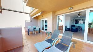 a living room with blue chairs and a table at Ginkgo 302891-A Murcia Holiday Rentals Property in Los Martínez