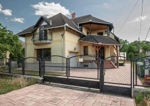 a fence in front of a house at Sunrise Airport Inn - Free Parking in Budapest