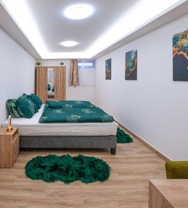 a bedroom with a bed with green sheets and rugs at Sunrise Airport Inn - Free Parking in Budapest