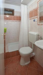 a bathroom with a toilet and a tub and a sink at Sunrise Airport Inn - Free Parking in Budapest