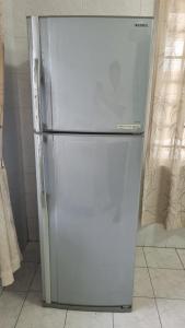 a white refrigerator sitting in a kitchen at Pujut 1 Homestay in Miri