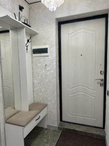 a closet with a white door and a white cabinet at 1 комнатная квартира видом на горы in Almaty