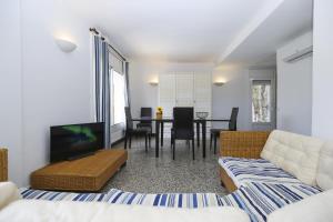 a living room with a couch and a table at Casa CODOLAR in Salou