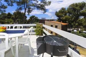 a balcony with a table and chairs and a grill at Casa CODOLAR in Salou +27 photos