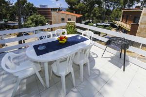 a white table and white chairs on a balcony at Casa CODOLAR in Salou