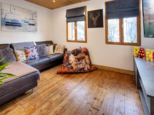 a living room with a couch and a chair at Chalet 5★, 15 pers, pied des pistes, spa extérieur, 7 chambres - FR-1-304-308 in La Clusaz