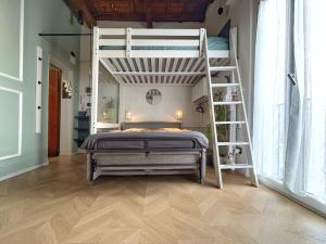a bedroom with a bunk bed and a ladder at Loft Biagio50 in Centro in Ferrara +11 photos