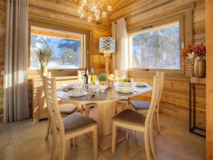 a dining room with a wooden table and chairs at Chalet luxe 5★, 6 pers, hammam, près des pistes, 3 chambres - FR-1-304-305 in La Clusaz