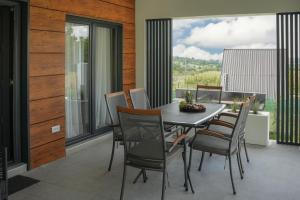 a dining room with a table and chairs on a balcony at Aeri Nature Concept in Baljevac