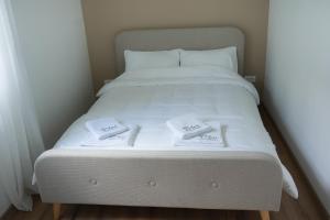 a white bed with two folded towels on it at Aeri Nature Concept in Baljevac +37 photos