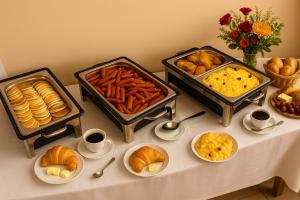 a table with several trays of different types of food at Plaza Hotel Gyula in Gyula +49 photos