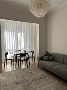 a living room with a table and a couch at Квартира in Almaty