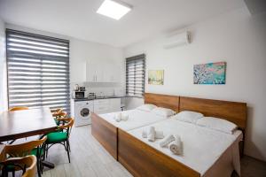 Un dormitorio con una cama y una mesa y una cocina. en Central Girne Escape by HolidayKeys, en Kyrenia