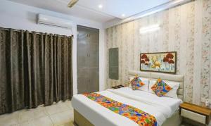 a bedroom with a large bed in a room at FabHotel Comfirt Inn in Noida