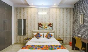 a bedroom with a large bed in a room at FabHotel Comfirt Inn in Noida