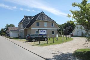 a large house with a lease sign in front of it at Ferienwohnung de lütte Leive in Born in Born