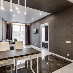 a dining room with a table and a couch at Новобудова Трускавецька, Автовокзал, Шувар,Кінг Крос in Lviv