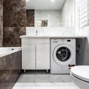 a white bathroom with a washing machine and a sink at Новобудова Трускавецька, Автовокзал, Шувар,Кінг Крос in Lviv