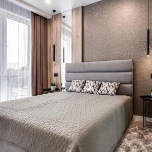 a bedroom with a large bed and a large window at Новобудова Трускавецька, Автовокзал, Шувар,Кінг Крос in Lviv