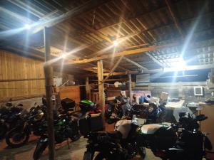 a group of motorcycles parked in a garage at Bella montanha pousada e camping in Lauro Müller