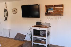 a living room with a tv on a wall at Boddenkahn in Born