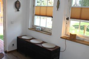 a room with two windows and a bench with two stools at Boddenkahn in Born +21 photos