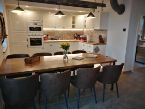 a kitchen with a large wooden table and chairs at Boddenkutter in Born