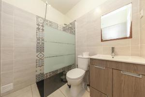 a bathroom with a toilet and a sink and a mirror at Lagos Center Apartment in Lagos +69 photos
