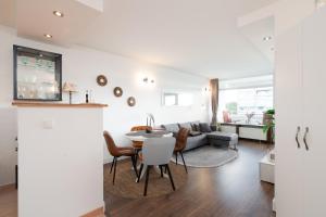 a living room with a table and a couch at Panoramic B03-1 in Sierksdorf