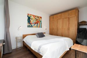 a bedroom with a large bed with a wooden headboard at Panoramic B03-1 in Sierksdorf