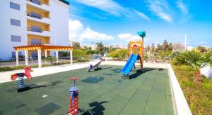 a playground in a building with children playing on it at Palmeiras Paz Apartment in Lagos