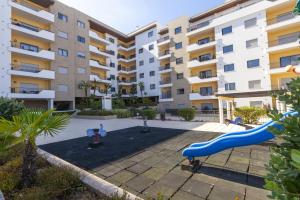 a playground in front of a apartment building at A68 - Palmeiras Paz Apartment in Lagos
