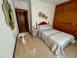 a bedroom with a bed and a wooden door at Apartamento Brisa Mar in Famara