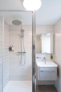 a bathroom with a shower and a sink at Gwbert Holiday Cottages, Riversmouth in Gwbert