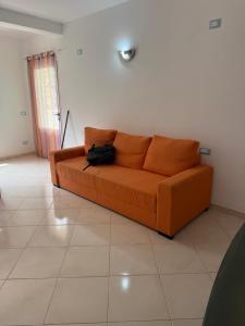 an orange couch sitting in a living room at Estrela do Mar 6F in Santa Maria