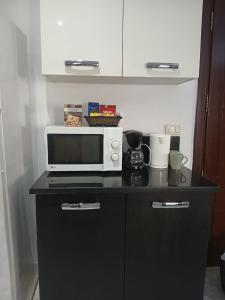 a microwave sitting on top of a counter at Locationsecurity in Tunis
