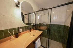 a bathroom with a sink and a shower with a mirror at Pastel İstanbul in Istanbul