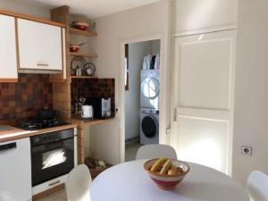 una cucina con un tavolo con una ciotola di frutta sopra di Appartement au cœur des Cévennes ad Avèze