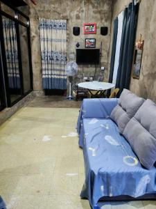 a living room with a couch and a table at Belmoro Transient House in Bacacay