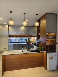 a large kitchen with a counter with a refrigerator at Private Villa by YUSETH Residence in Phumi Ta Phul
